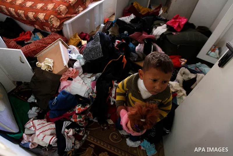 A Palestinian woman checks her belongings after a raid conducted by the Israeli army on some Palestinian houses in the West Bank city of Hebron, 29 February 2016. The Israeli army said it had arrested 16 Palestinians in...