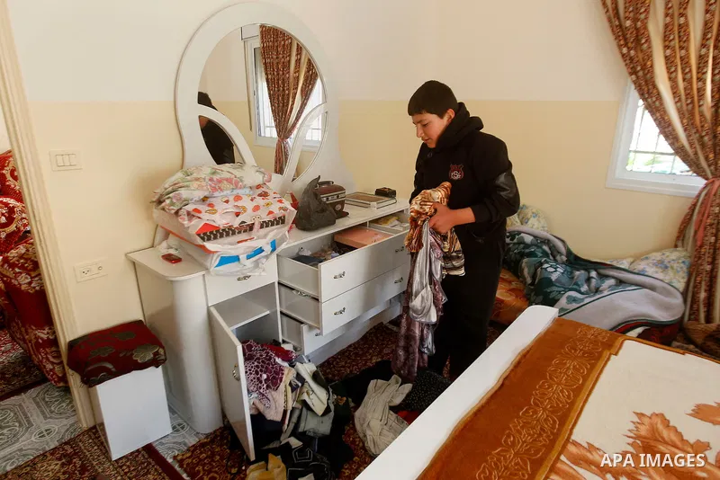 A Palestinian boy checks his belongings after a raid conducted by the Israeli army on some Palestinian houses in the West Bank city of Hebron, 29 February 2016. The Israeli army said it had arrested 16 Palestinians in He...