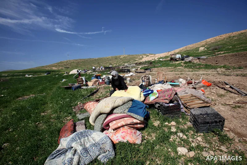 A Palestinian woman inspects the rubble of her tent that was demolished by the Israeli army, in the West Bank town of Tubas on February 29, 2016. Israel is planning to annex the Jordan Valley into a completely Israeli ar...