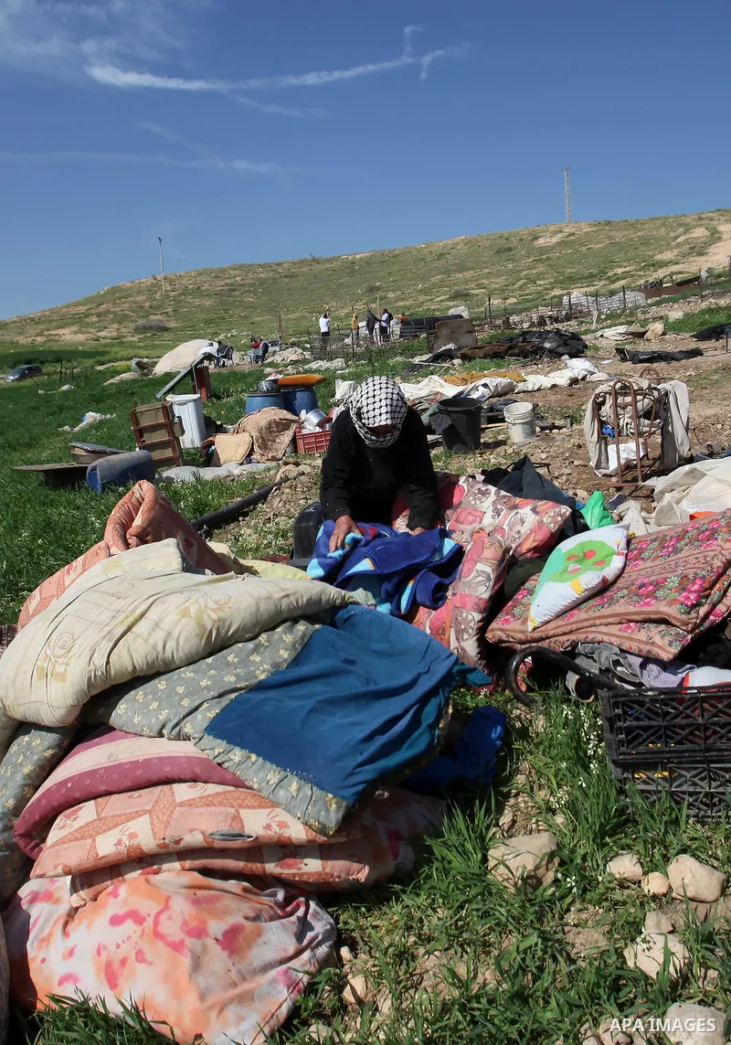 A Palestinian woman inspects the rubble of her tent that was demolished by the Israeli army, in the West Bank town of Tubas on February 29, 2016. Israel is planning to annex the Jordan Valley into a completely Israeli ar...