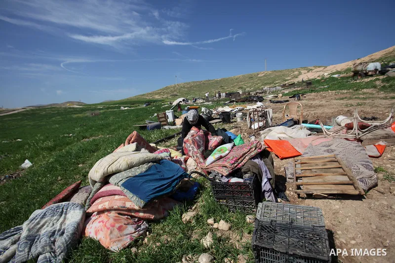 A Palestinian woman inspects the rubble of her tent that was demolished by the Israeli army, in the West Bank town of Tubas on February 29, 2016. Israel is planning to annex the Jordan Valley into a completely Israeli ar...