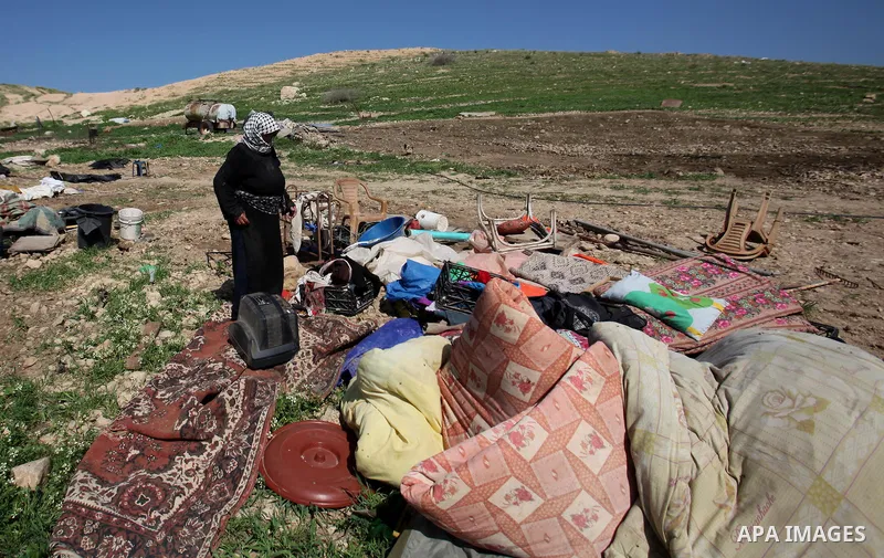 A Palestinian woman inspects the rubble of her tent that was demolished by the Israeli army, in the West Bank town of Tubas on February 29, 2016. Israel is planning to annex the Jordan Valley into a completely Israeli ar...