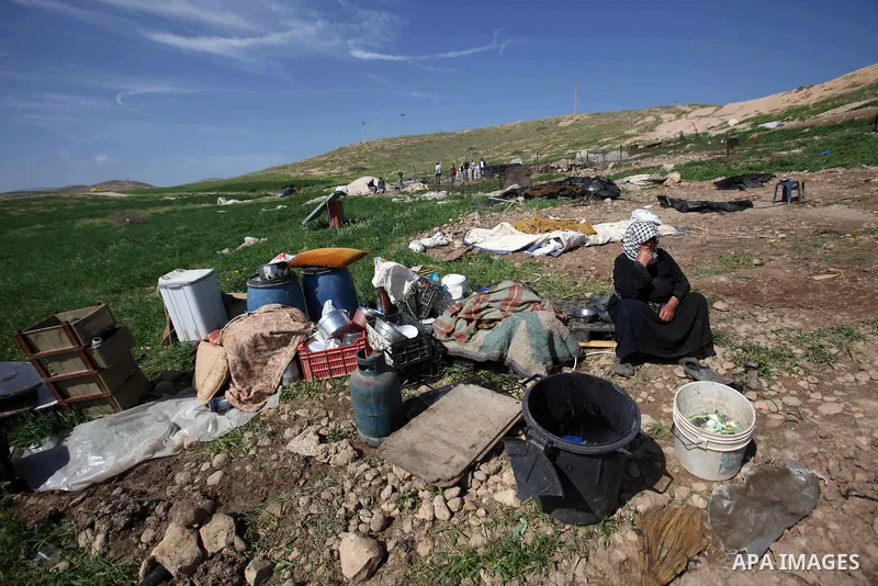 A Palestinian woman inspects the rubble of her tent that was demolished by the Israeli army, in the West Bank town of Tubas on February 29, 2016. Israel is planning to annex the Jordan Valley into a completely Israeli ar...