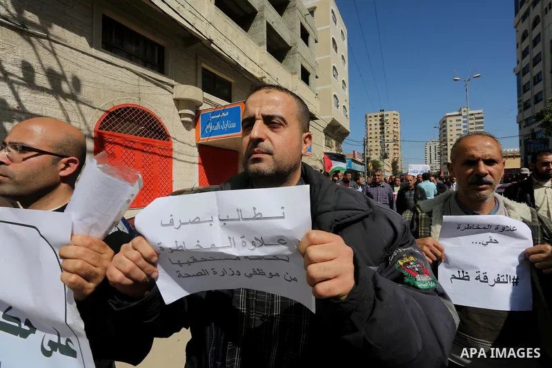 Employees of former Palestinian government take part in a protest to demand for pay their salaries, in Gaza city on March 1, 2016. Photo by Mohammed Asad