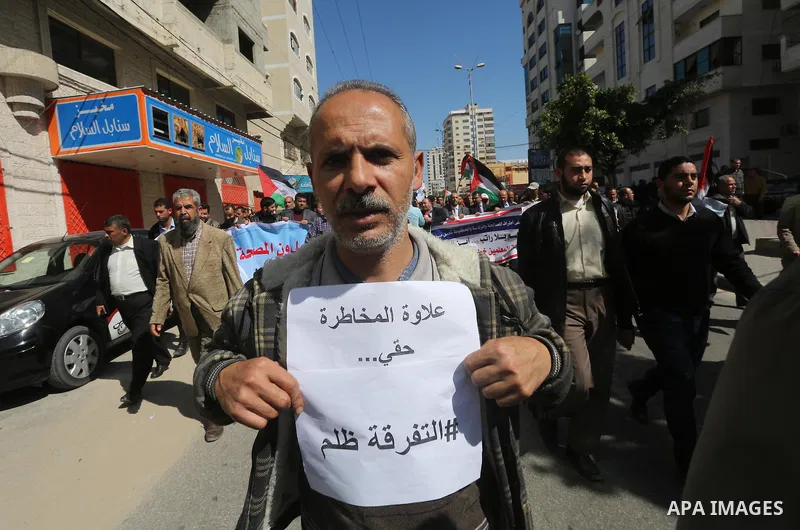 Employees of former Palestinian government take part in a protest to demand for pay their salaries, in Gaza city on March 1, 2016. Photo by Mohammed Asad
