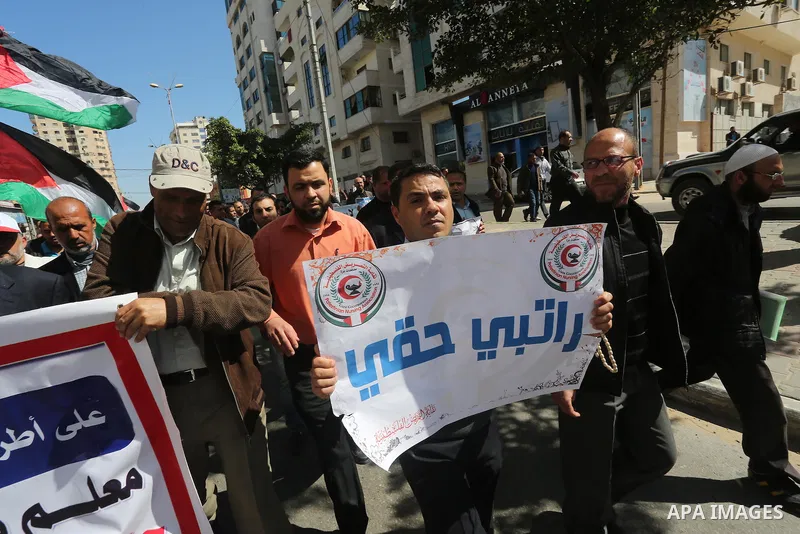 Employees of former Palestinian government take part in a protest to demand for pay their salaries, in Gaza city on March 1, 2016. Photo by Mohammed Asad