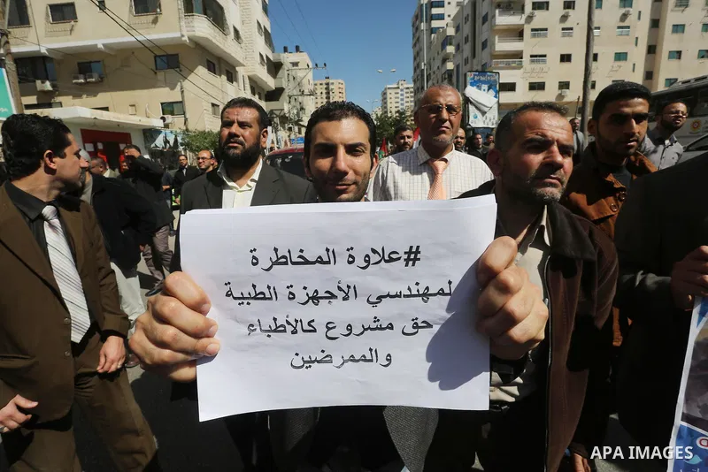 Employees of former Palestinian government take part in a protest to demand for pay their salaries, in Gaza city on March 1, 2016. Photo by Mohammed Asad