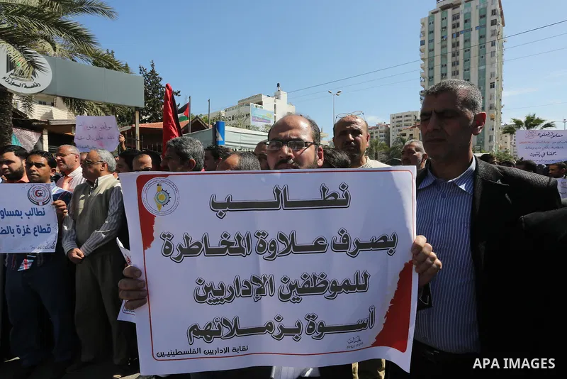 Employees of former Palestinian government take part in a protest to demand for pay their salaries, in Gaza city on March 1, 2016. Photo by Mohammed Asad