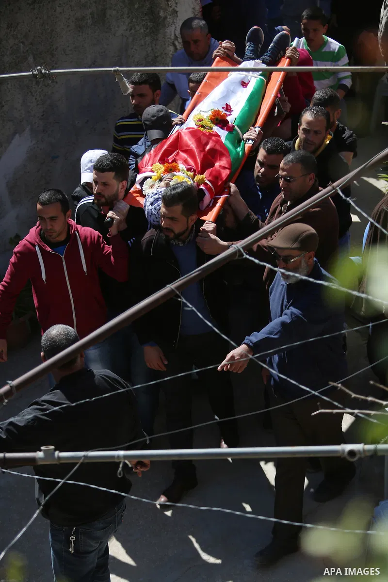 Mourners carry the body of 22-year-old Palestinian man Eyad Sajedeya, who medics said was shot dead by Israeli forces, during his funeral at Qalandia refugee camp near the West Bank city of Ramallah March 1, 2016. Israel...