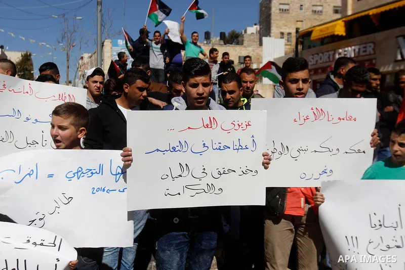 Palestinian school students take part during a protest to show solidarity with Palestinian teachers in their strike wihch entered its 16th consecutive day to call Palestinian Authority to demand their rights in the West...