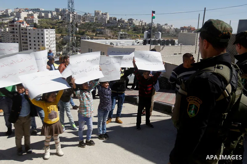 Palestinian school students take part during a protest to show solidarity with Palestinian teachers in their strike wihch entered its 16th consecutive day to call Palestinian Authority to demand their rights in the West...
