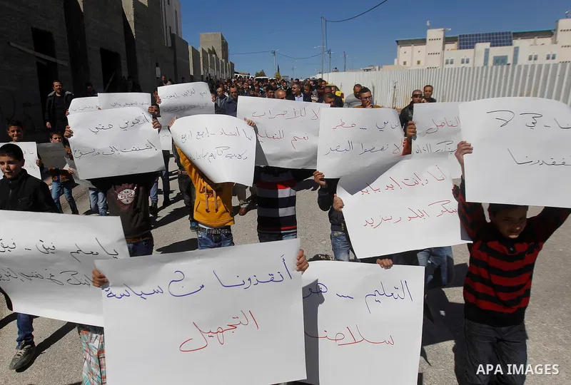 Palestinian school students take part during a protest to show solidarity with Palestinian teachers in their strike wihch entered its 16th consecutive day to call Palestinian Authority to demand their rights in the West...