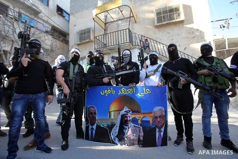Palestinian militants of Al-Aqsa Martyrs' Brigades, a group linked to the Fatah movement take part during a protest to show solidarity with Palestinian President Mahmoud Abbas and Palestinian Prime Minister Rami Hamdalla...
