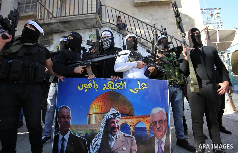 Palestinian militants of Al-Aqsa Martyrs' Brigades, a group linked to the Fatah movement take part during a protest to show solidarity with Palestinian President Mahmoud Abbas and Palestinian Prime Minister Rami Hamdalla...
