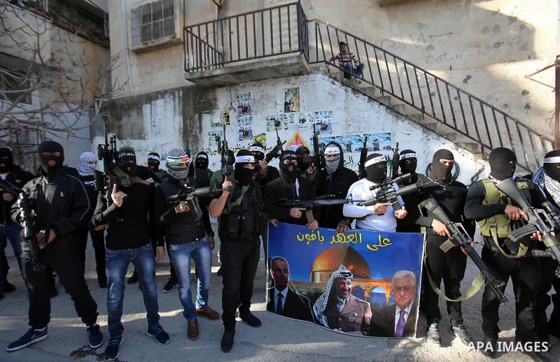 Palestinian militants of Al-Aqsa Martyrs' Brigades, a group linked to the Fatah movement take part during a protest to show solidarity with Palestinian President Mahmoud Abbas and Palestinian Prime Minister Rami Hamdalla...