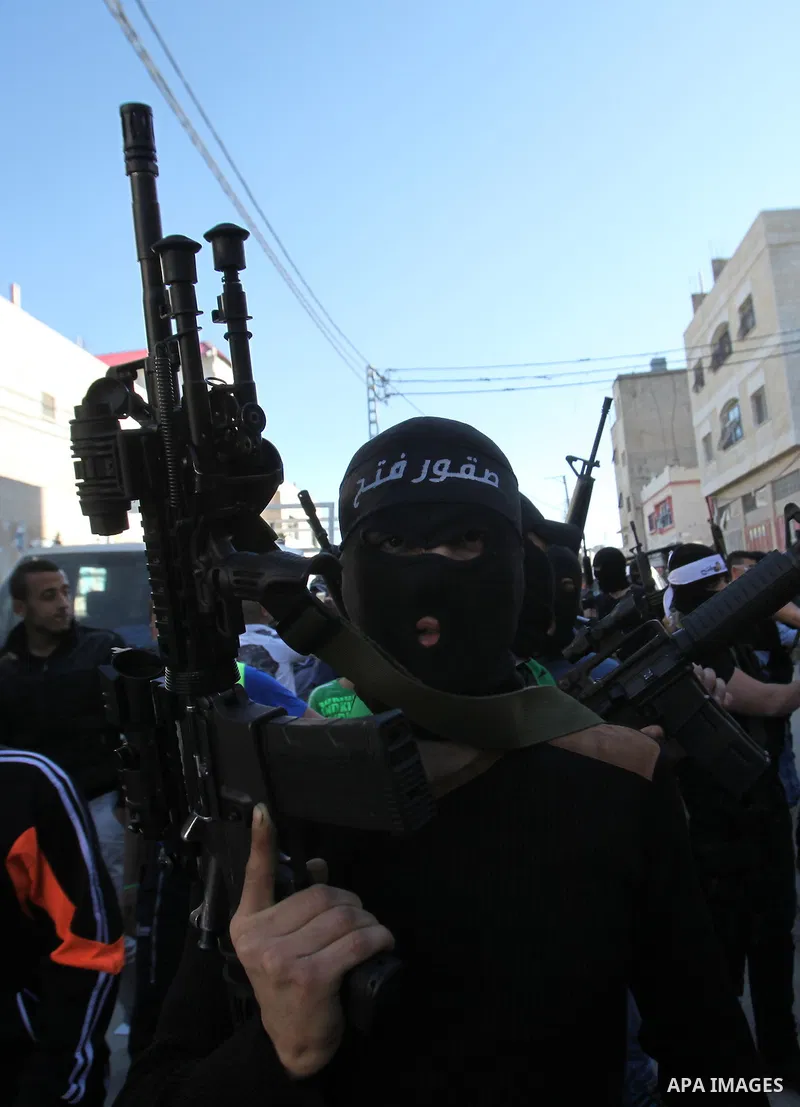 Palestinian militants of Al-Aqsa Martyrs' Brigades, a group linked to the Fatah movement take part during a protest to show solidarity with Palestinian President Mahmoud Abbas and Palestinian Prime Minister Rami Hamdalla...