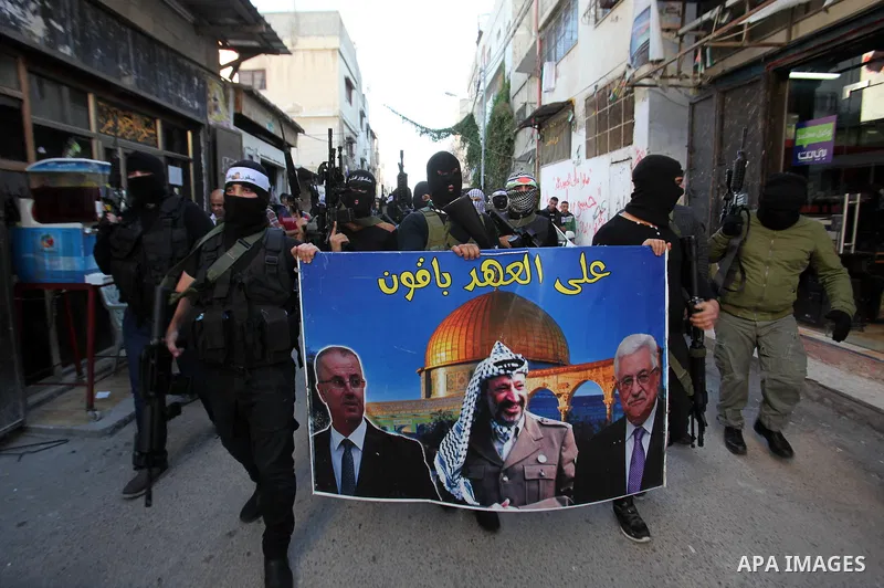 Palestinian militants of Al-Aqsa Martyrs' Brigades, a group linked to the Fatah movement take part during a protest to show solidarity with Palestinian President Mahmoud Abbas and Palestinian Prime Minister Rami Hamdalla...