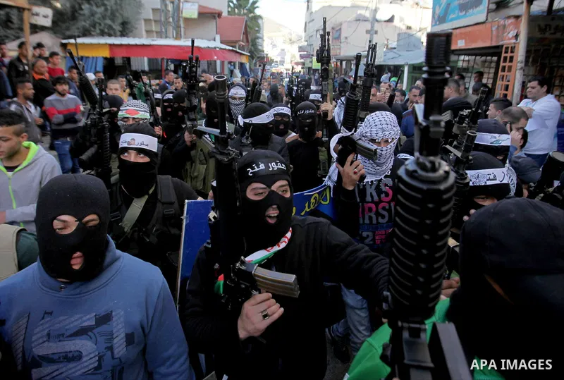 Palestinian militants of Al-Aqsa Martyrs' Brigades, a group linked to the Fatah movement take part during a protest to show solidarity with Palestinian President Mahmoud Abbas and Palestinian Prime Minister Rami Hamdalla...