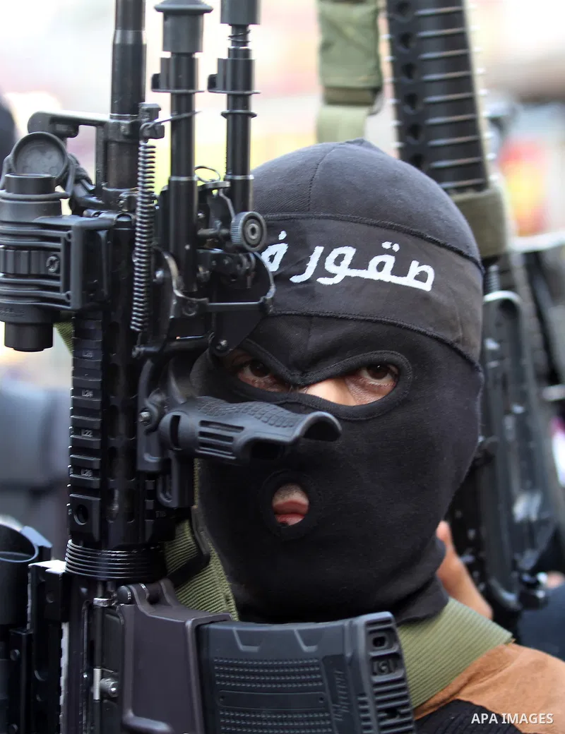Palestinian militants of Al-Aqsa Martyrs' Brigades, a group linked to the Fatah movement take part during a protest to show solidarity with Palestinian President Mahmoud Abbas and Palestinian Prime Minister Rami Hamdalla...
