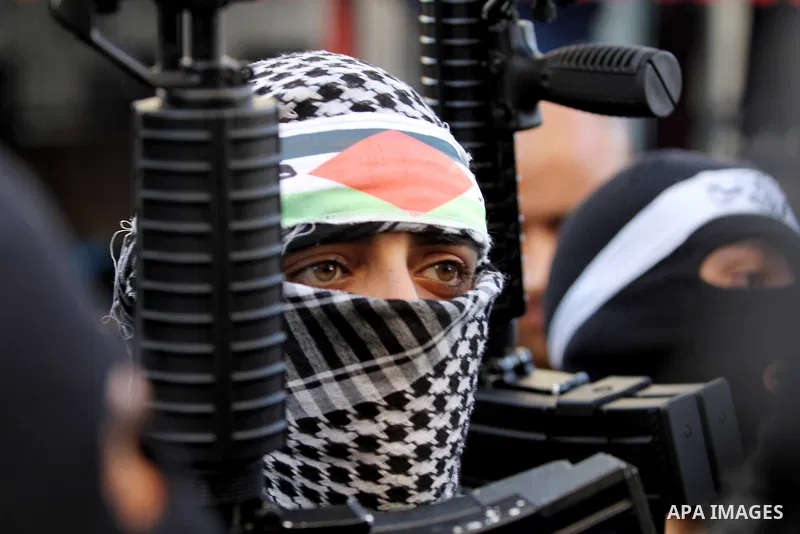 Palestinian militants of Al-Aqsa Martyrs' Brigades, a group linked to the Fatah movement take part during a protest to show solidarity with Palestinian President Mahmoud Abbas and Palestinian Prime Minister Rami Hamdalla...