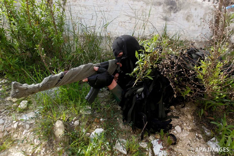 Members of Palestinian national security forces show their skills during a military training, in the West Bank city of Hebron, on March 2, 2016. Photo by Wisam Hashlamoun