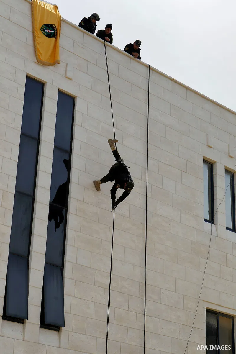 Members of Palestinian national security forces show their skills during a military training, in the West Bank city of Hebron, on March 2, 2016. Photo by Wisam Hashlamoun