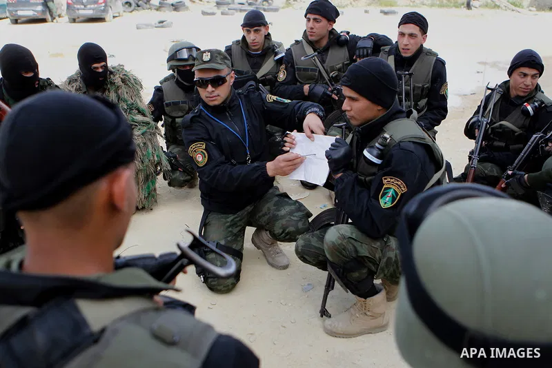 Members of Palestinian national security forces show their skills during a military training, in the West Bank city of Hebron, on March 2, 2016. Photo by Wisam Hashlamoun