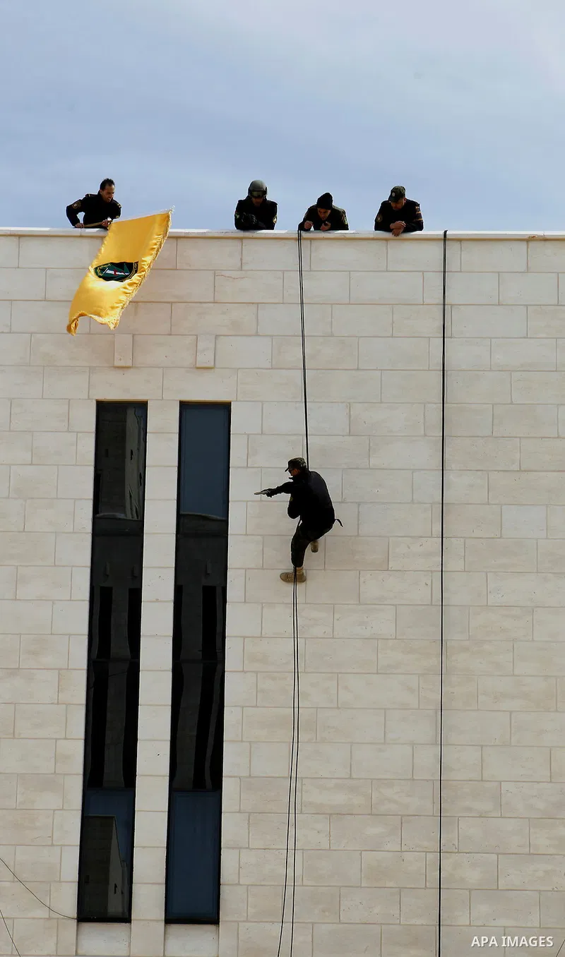 Members of Palestinian national security forces show their skills during a military training, in the West Bank city of Hebron, on March 2, 2016. Photo by Wisam Hashlamoun