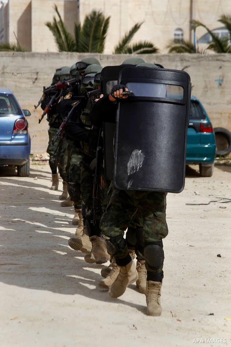 Members of Palestinian national security forces show their skills during a military training, in the West Bank city of Hebron, on March 2, 2016. Photo by Wisam Hashlamoun