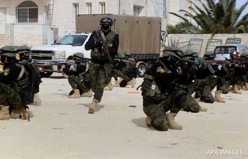 Members of Palestinian national security forces show their skills during a military training, in the West Bank city of Hebron, on March 2, 2016. Photo by Wisam Hashlamoun