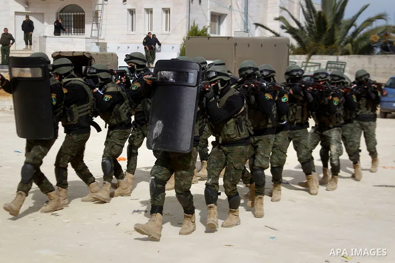 Members of Palestinian national security forces show their skills during a military training, in the West Bank city of Hebron, on March 2, 2016. Photo by Wisam Hashlamoun