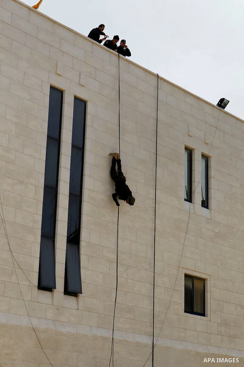 Members of Palestinian national security forces show their skills during a military training, in the West Bank city of Hebron, on March 2, 2016. Photo by Wisam Hashlamoun