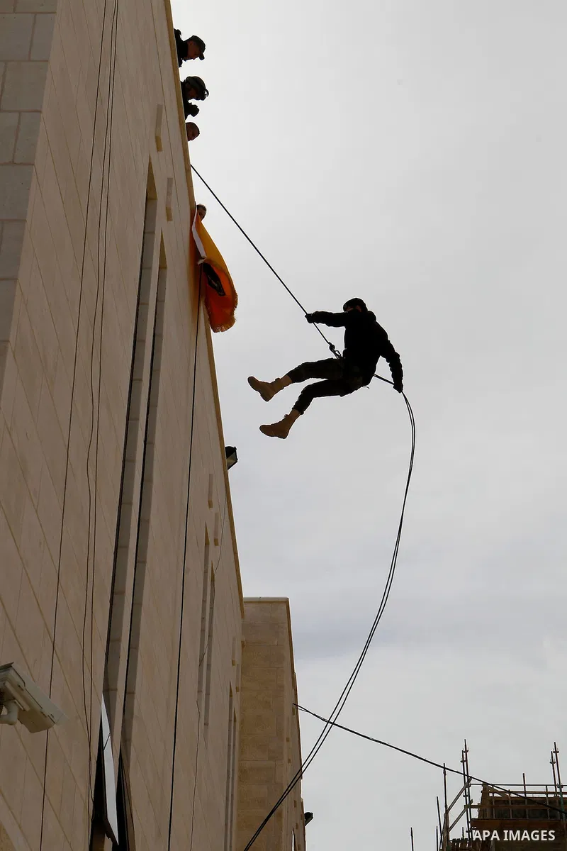 Members of Palestinian national security forces show their skills during a military training, in the West Bank city of Hebron, on March 2, 2016. Photo by Wisam Hashlamoun