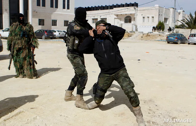 Members of Palestinian national security forces show their skills during a military training, in the West Bank city of Hebron, on March 2, 2016. Photo by Wisam Hashlamoun