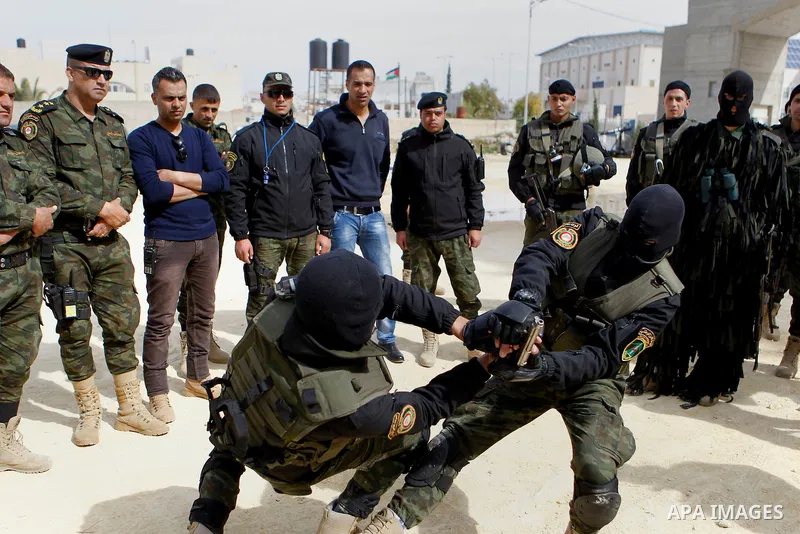 Members of Palestinian national security forces show their skills during a military training, in the West Bank city of Hebron, on March 2, 2016. Photo by Wisam Hashlamoun