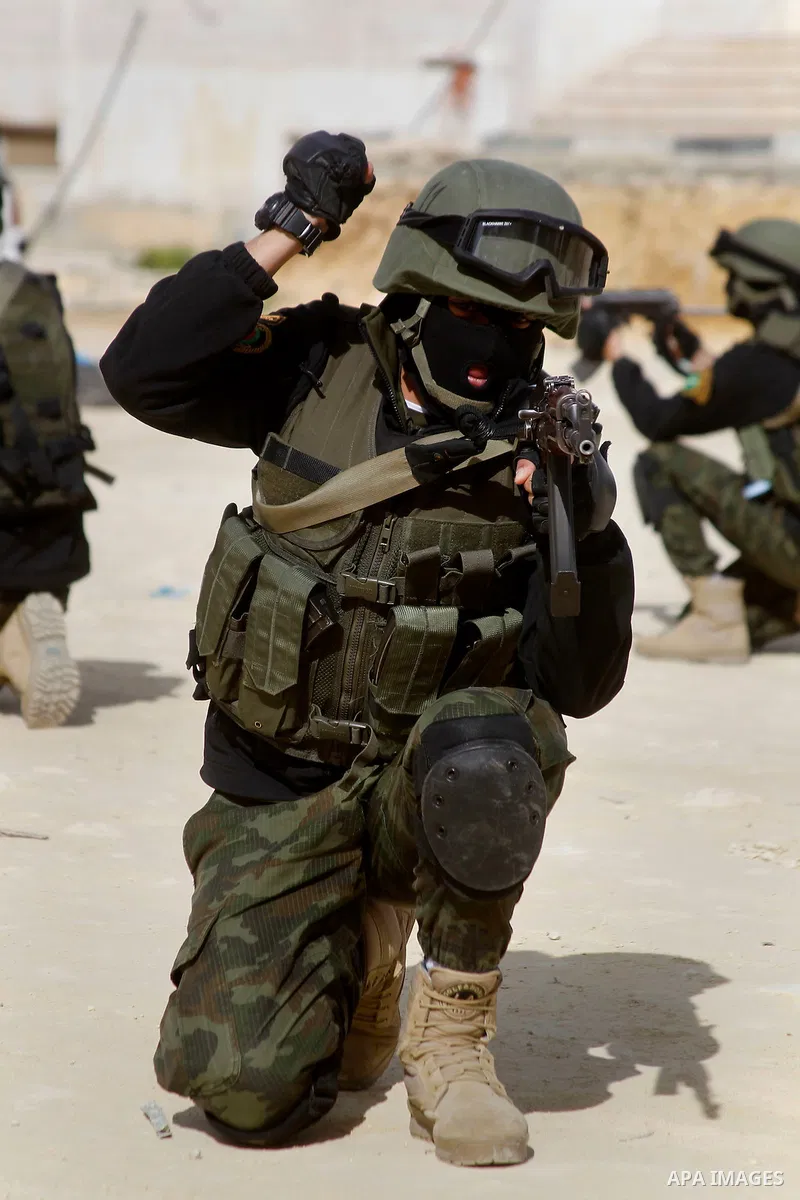 Members of Palestinian national security forces show their skills during a military training, in the West Bank city of Hebron, on March 2, 2016. Photo by Wisam Hashlamoun