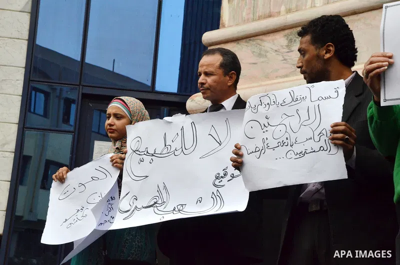 Egyptians hold placards during a demonstration to protest against the normalizing Israeli-Egyptian relations in front of journalists syndicate in Cairo, Egypt, on March 02, 2016. Photo by Amr Sayed