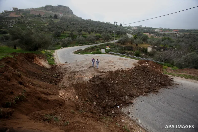 Palestinians try to access their village during the closure of the entrance to the villages of Tel and Iraq Burin near the West Bank city of Nablus, on March 3, 2016. Israeli forces closed all roads leaving Nablus city a...