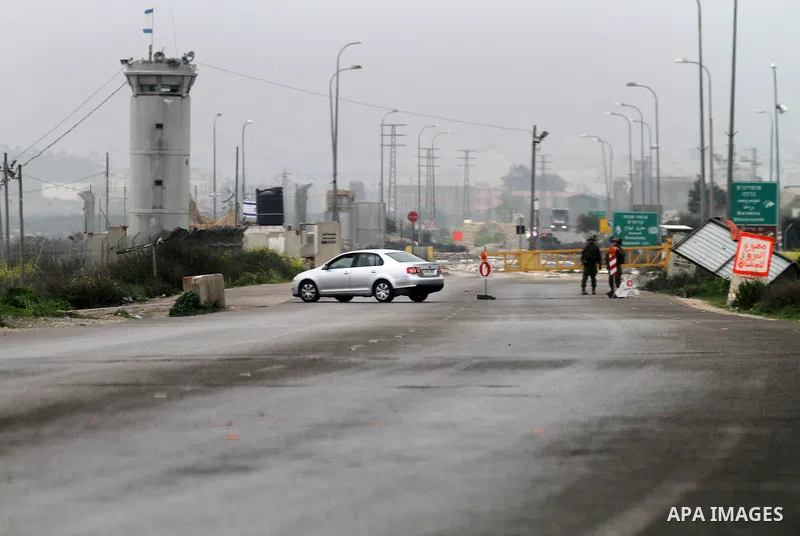 Israeli security forces stand guard at the Hawara checkpoint, south of the West Bank city of Nablus, on March 3, 2016. Israeli forces closed all roads leaving Nablus city and shut the entrances to nearby villages after t...