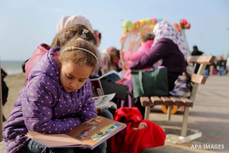 Palestinian activists participate in a reading human chain at the beach of Gaza city on March 03, 2016. Photo by Mohammed Asad