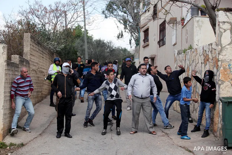Palestinian protesters hurl stones towards Israeli security forces during clashes following a demonstration against the expropriation of Palestinian land by Israel in the village of Kfar Qaddum, near Nablus, in the occup...