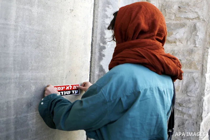 Peace activist take part during a joint Israeli-Palestinian peace march along the Israeli controvertial separation wall in the West Bank city of Beit Jala between Bethlehem and Jerusalem, on March 4, 2016. Peace activist...
