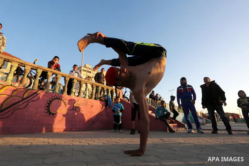 Palestinian youths show their parkour skills at the beach of Gaza city on March 04, 2016. Photo by Mohammed Asad