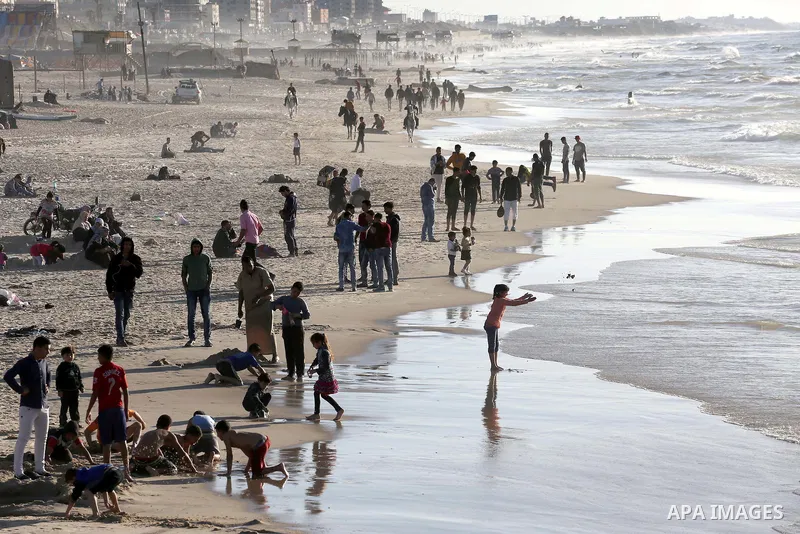 Palestinians enjoy a day at the beach of the Mediterranean Sea on the coast of Gaza City, on March 04, 2016. Photo by Mohammed Asad