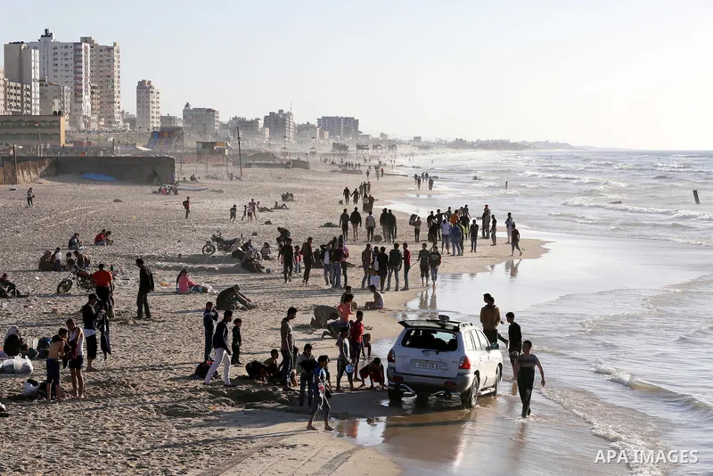 Palestinians enjoy a day at the beach of the Mediterranean Sea on the coast of Gaza City, on March 04, 2016. Photo by Mohammed Asad