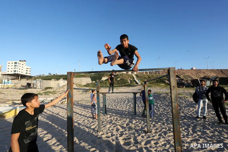 Palestinian youths show their parkour skills at the beach of Gaza city on March 04, 2016. Photo by Mohammed Asad