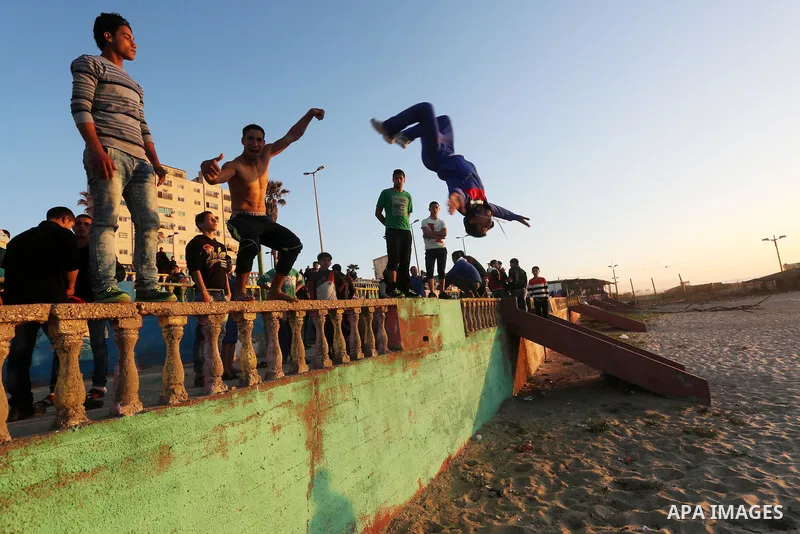 Palestinian youths show their parkour skills at the beach of Gaza city on March 04, 2016. Photo by Mohammed Asad