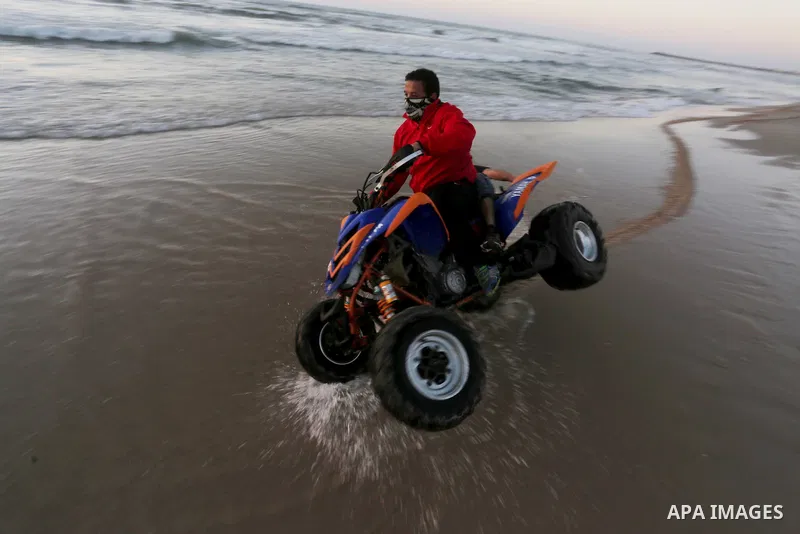 Palestinians enjoy a day at the beach of the Mediterranean Sea on the coast of Gaza City, on March 04, 2016. Photo by Mohammed Asad
