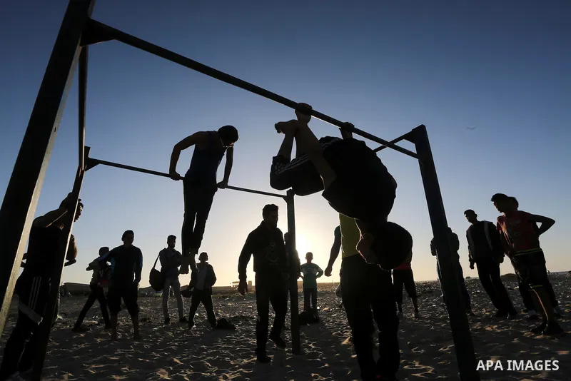 Palestinian youths show their parkour skills at the beach of Gaza city on March 04, 2016. Photo by Mohammed Asad