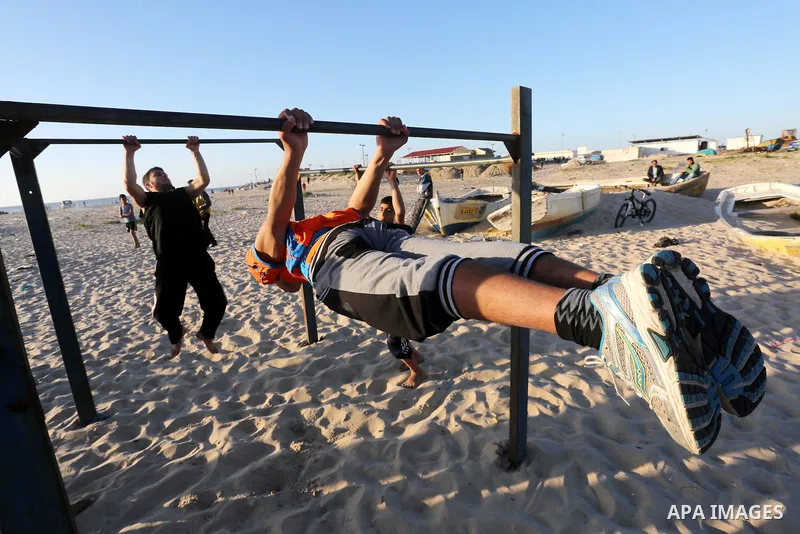 Palestinian youths show their parkour skills at the beach of Gaza city on March 04, 2016. Photo by Mohammed Asad